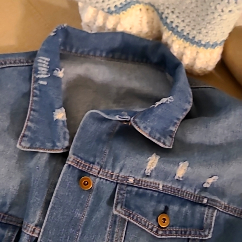 Long sleeved distressed jean jacket